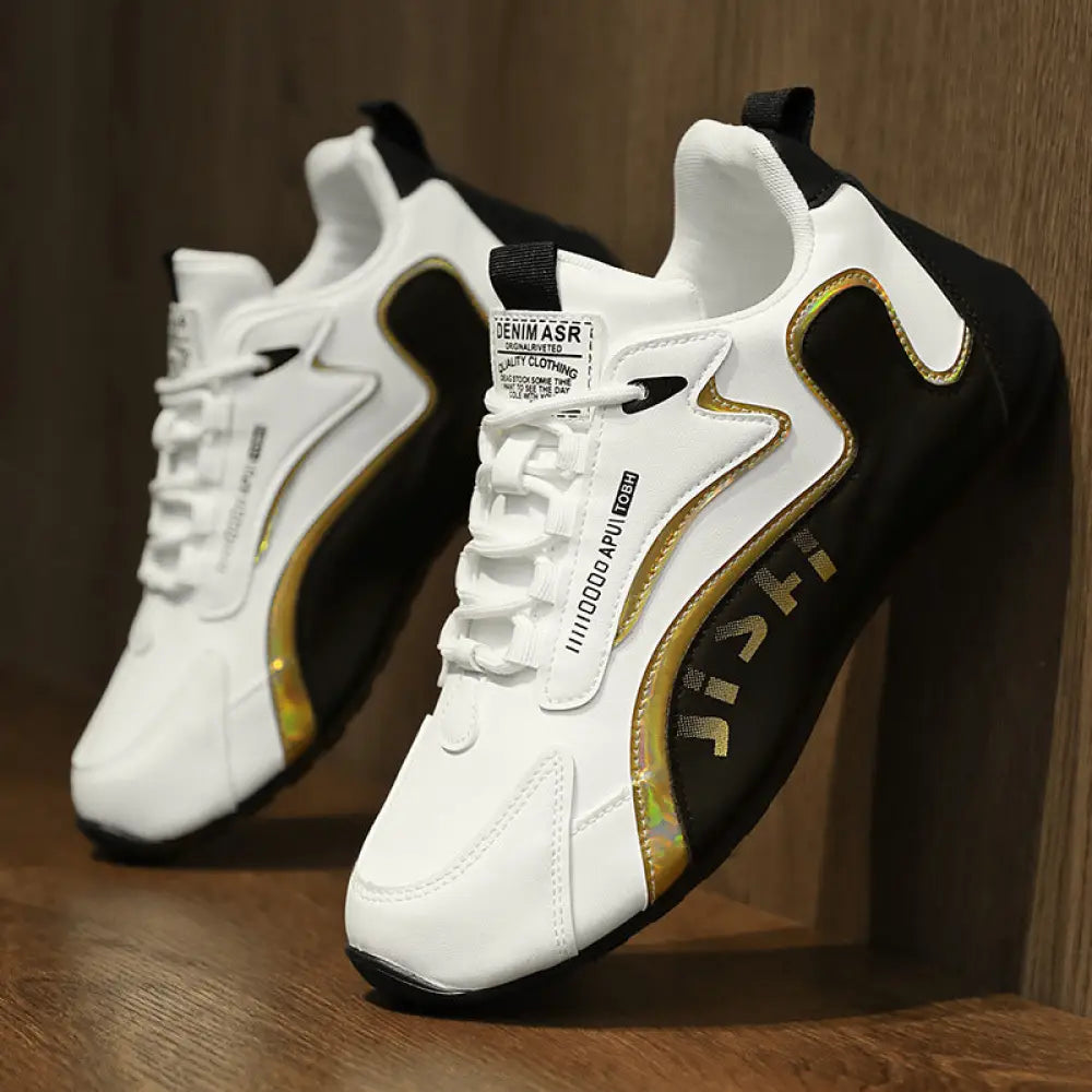 Men’s colorblock breathable mesh sport sneakers in white and black with gold accents and branded text on the side
