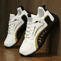 Men’s colorblock breathable mesh sport sneakers in white and black with gold accents and branded text on the side