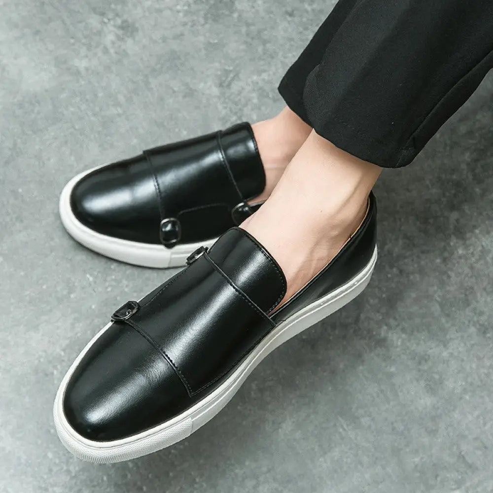 Men’s black leather slip-on loafers with double monk strap buckles and white rubber soles for fashion use