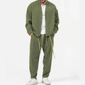 Men’s olive green slim fit casual blazer with matching drawstring pants and white sneakers for smart business wear
