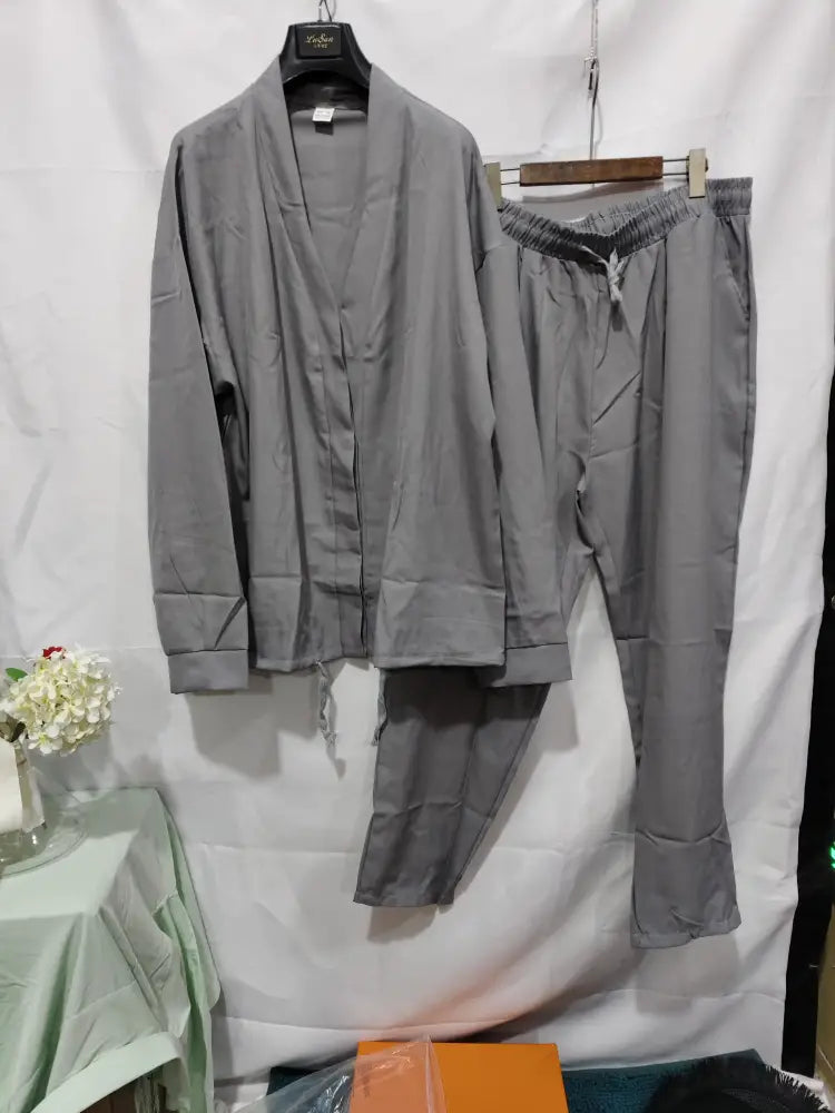 Gray pajama set with button-up top and drawstring pants paired with men’s Korean slim fit business blazer