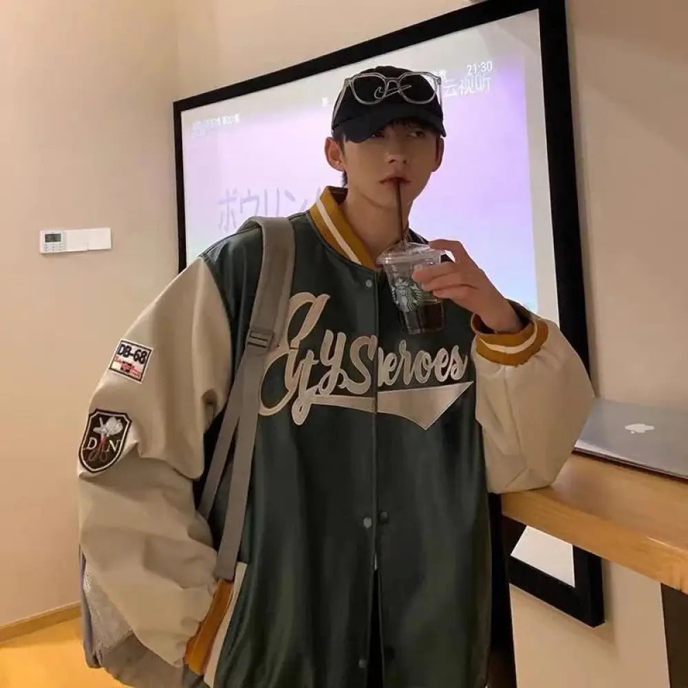 Men’s embroidered PU leather baseball bomber jacket in dark green and beige with gold trim and white cursive gysheroes logo