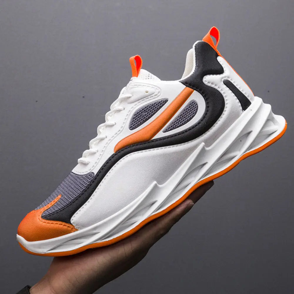 Men modern mesh non slip athletic running sneaker in white orange and black with sleek design and bold sculpted sole