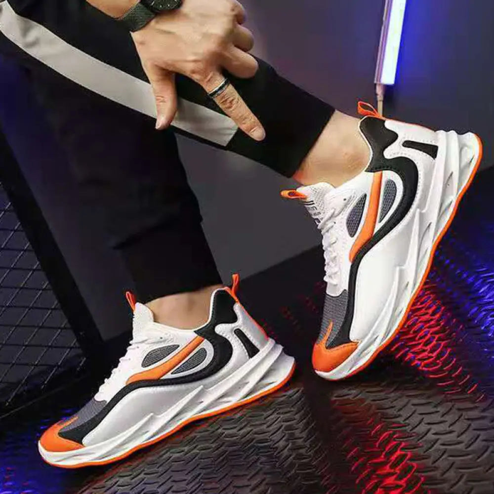 Men modern mesh non slip athletic running sneakers in white black and orange with sleek design and bold color accents