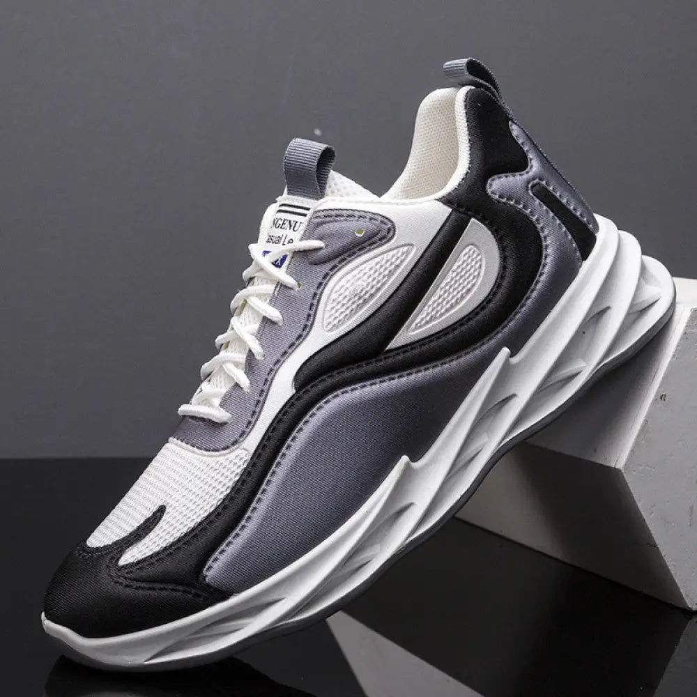 A sleek men modern mesh non slip athletic running sneaker in black white with gray mesh panels for enhanced breathability