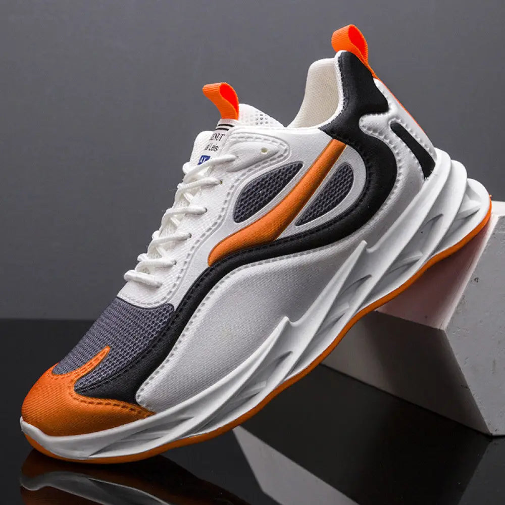 Men modern mesh non slip athletic running sneaker in white black and orange with a breathable mesh upper and bold accents