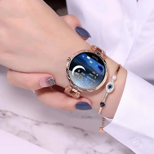 Arbaglobal women’s rose gold waterproof fitness smartwatch with circular face ornate bezel and illuminated time and date display