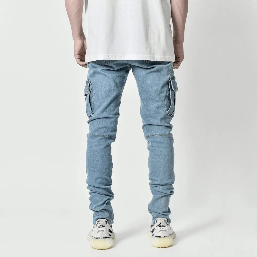 Slim fit distressed light-wash denim cargo jeans with reinforced knee patches and multiple side pockets