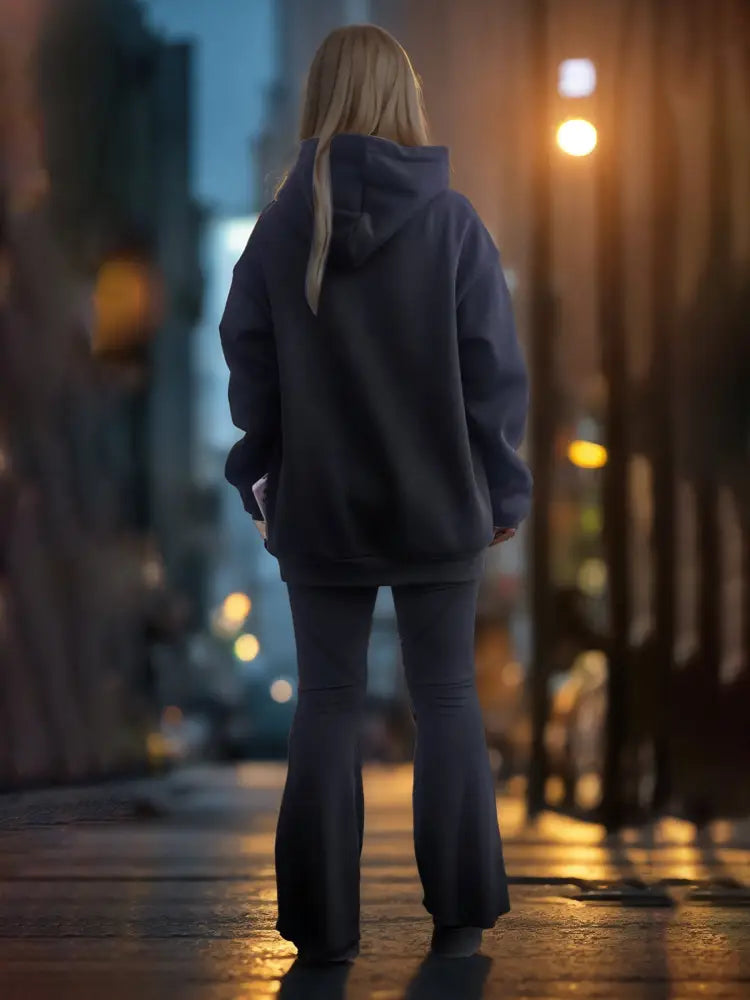 Dark gray oversized premium cotton unisex embroidered streetwear hoodie with hood and long sleeves on city street