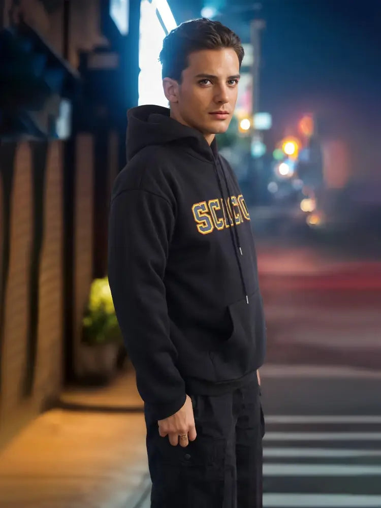 Black premium cotton unisex hoodie with gold embroidered lettering across the chest for streetwear use