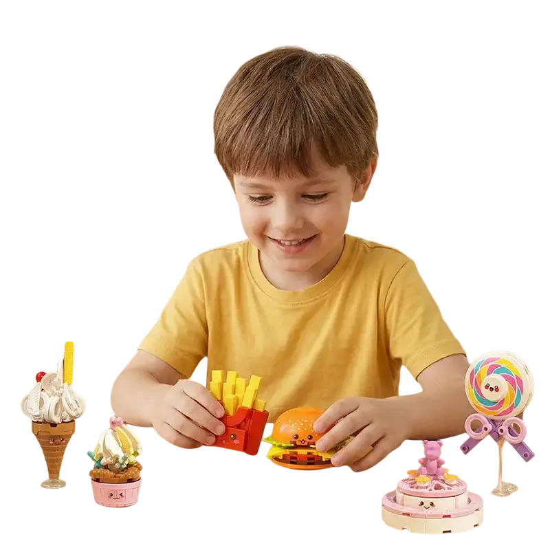 A child holds a bright orange cartoonish burger toy with yellow fries and green lettuce from fast food micro building block set