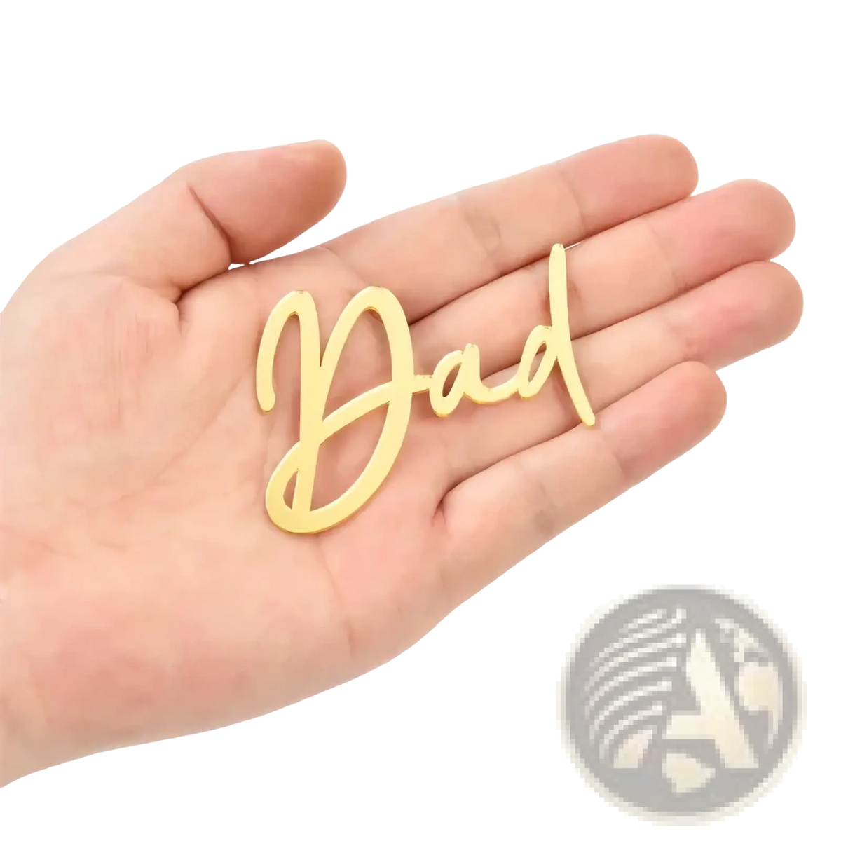 Hand holding gold-colored cursive dad plaque made of black and gold acrylic for Father’s Day cake topper