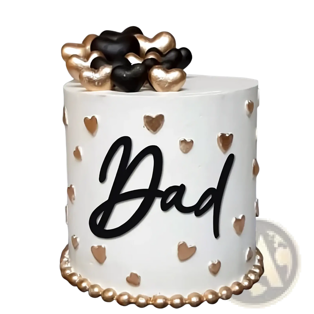 Father’s day dad cake topper in black and gold acrylic on a white frosted cake with gold and black heart decorations