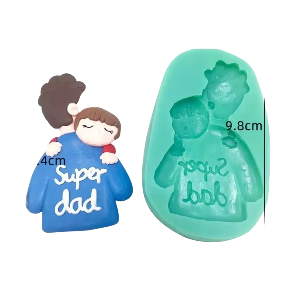 A turquoise silicone mold and blue resin figurine shaped like a father and child with super dad on the shirt for cake decor