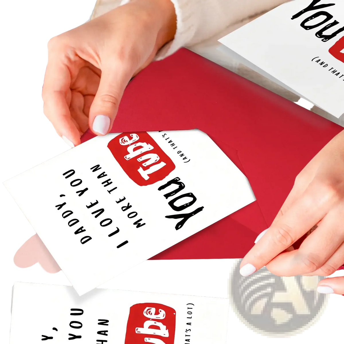 White greeting card with black text and red youtube logo held over red envelope in father’s day youtube greeting card set