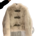 Cream-colored faux fur coat with three horizontal leather buckle straps across the front for stylish warmth
