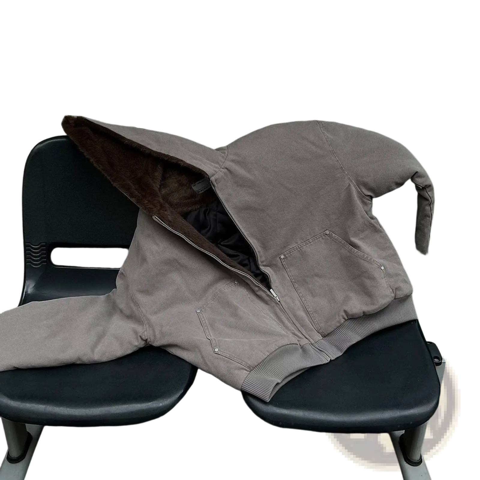 Beige faux fur lined cotton padded winter coat with brown fleece lining and silver zipper pulls on black bench