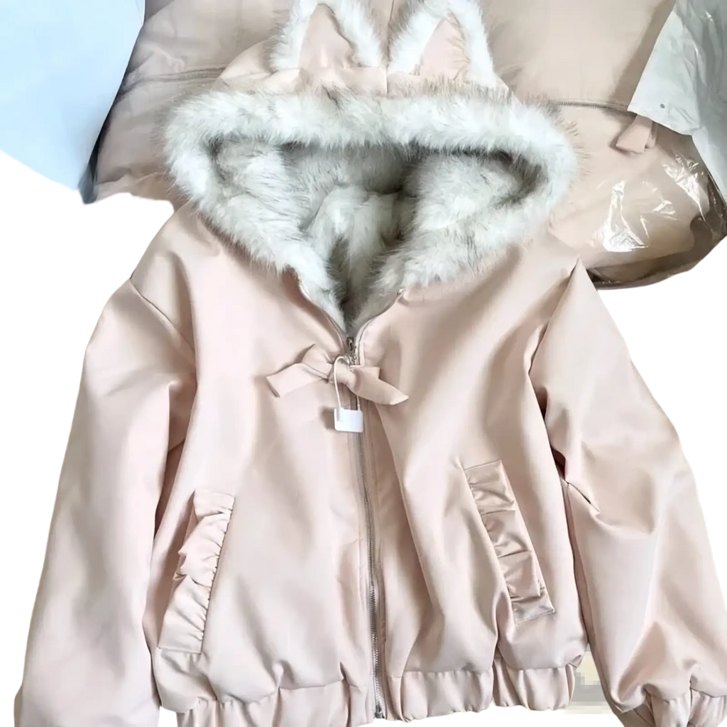A soft pink faux fur puffer jacket for women with a fluffy white cat ear hood and ruffled pockets winter outerwear