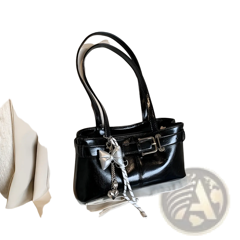 Black faux leather shoulder bag with silver buckle and bow charm featuring a glossy patent finish