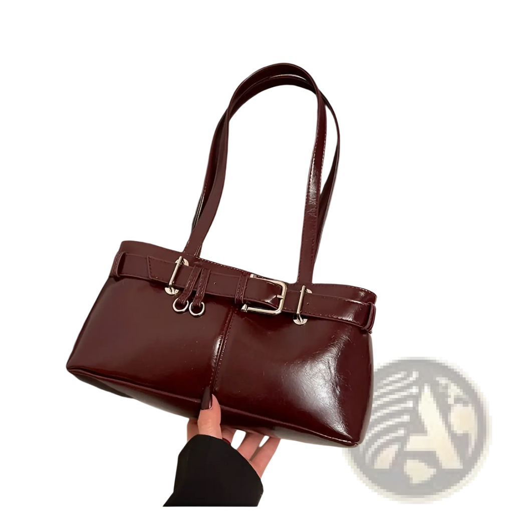 Glossy burgundy faux leather buckle shoulder bag with silver-toned straps and structured rectangular design with bow charm