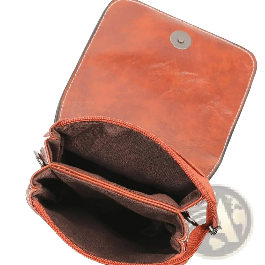 A tan faux leather floral and sunburst crossbody phone bag with zipper closure and dark brown interior lining