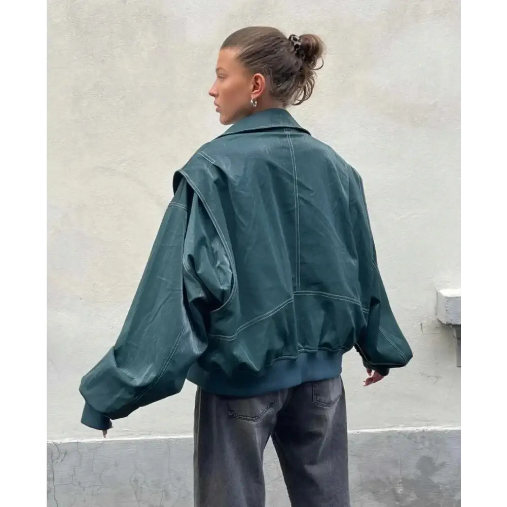 Dark teal faux leather streetwear jacket for women with exaggerated sleeves and contrasting white stitching