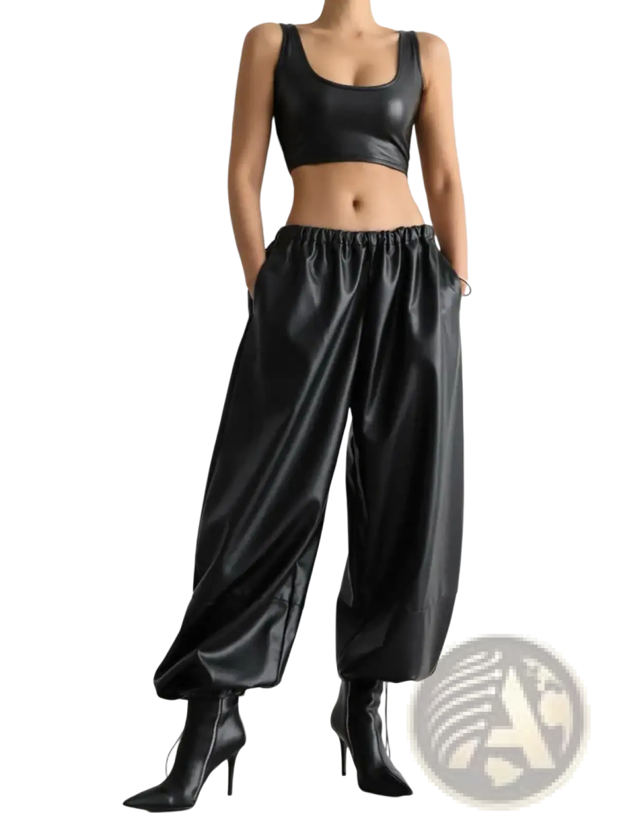 Black faux leather tapered pants featuring a glossy finish and elastic waistband for comfortable wear