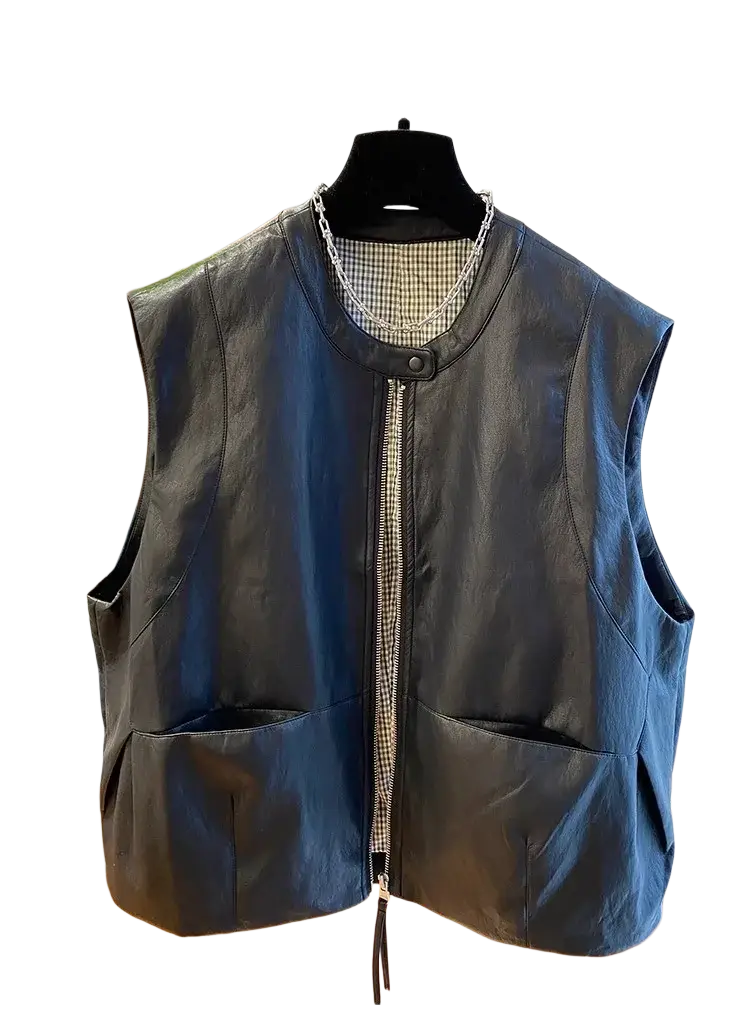 Black faux leather vest for women with zipper front, two large patch pockets, and subtle checkered lining at neckline