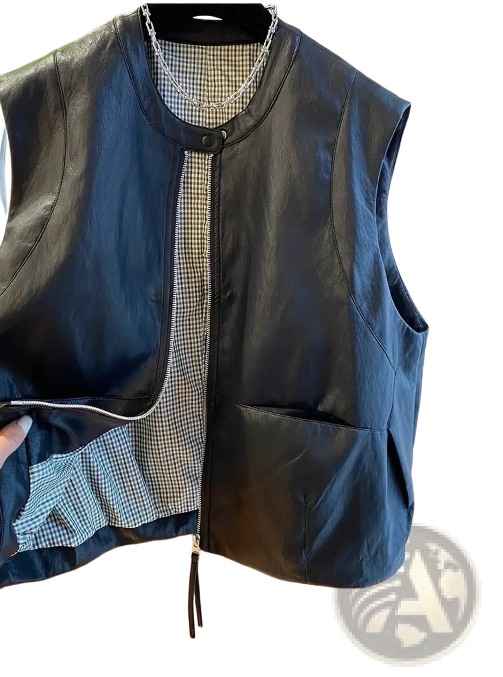 Black faux leather vest for women with front zipper closure and checkered interior lining for casual outerwear