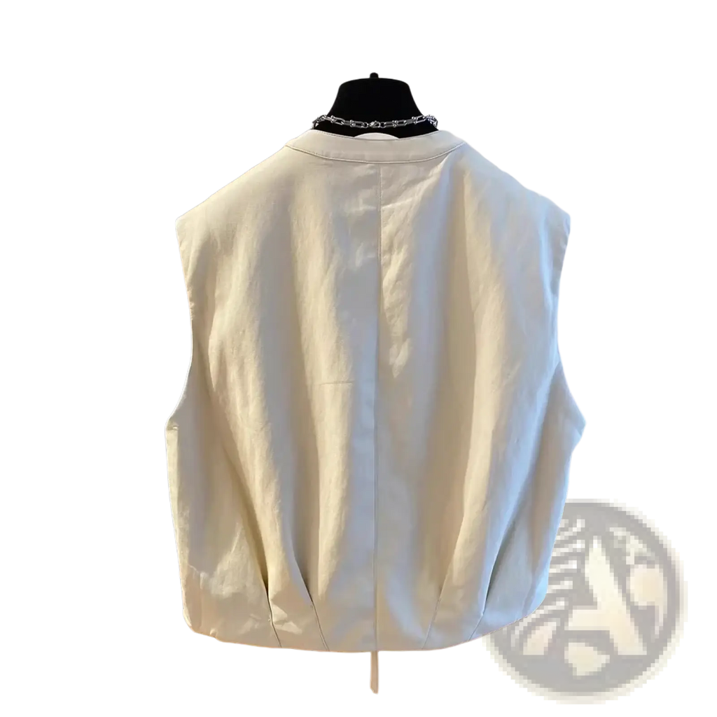 Cream-colored faux leather sleeveless vest with relaxed fit and zip pocket for casual women’s outerwear