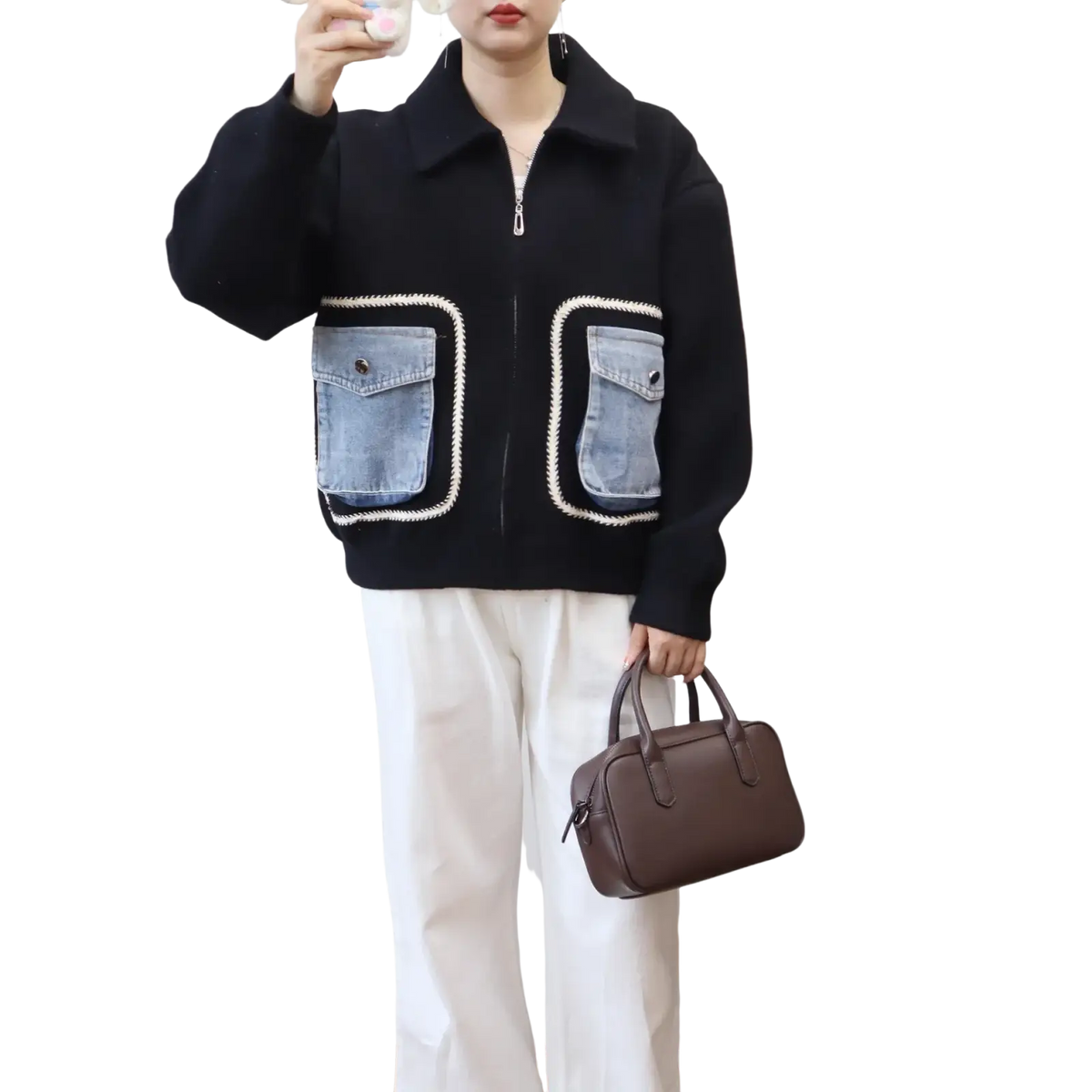 Brown leather handbag with top handles and structured rectangular shape complementing faux shearling denim pocket jacket