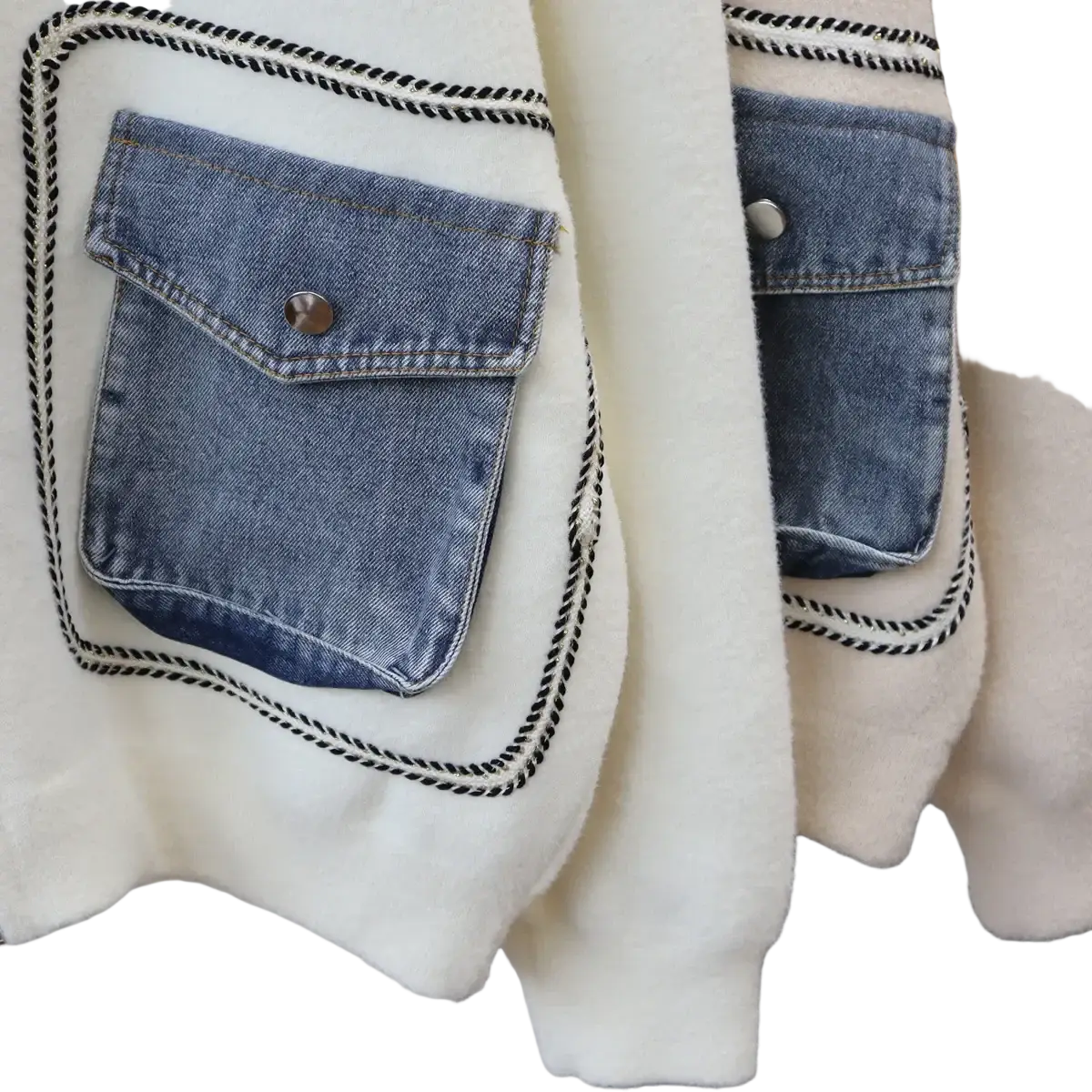 White faux shearling jacket with denim patch pockets and black-trimmed stitching for stylish outerwear use