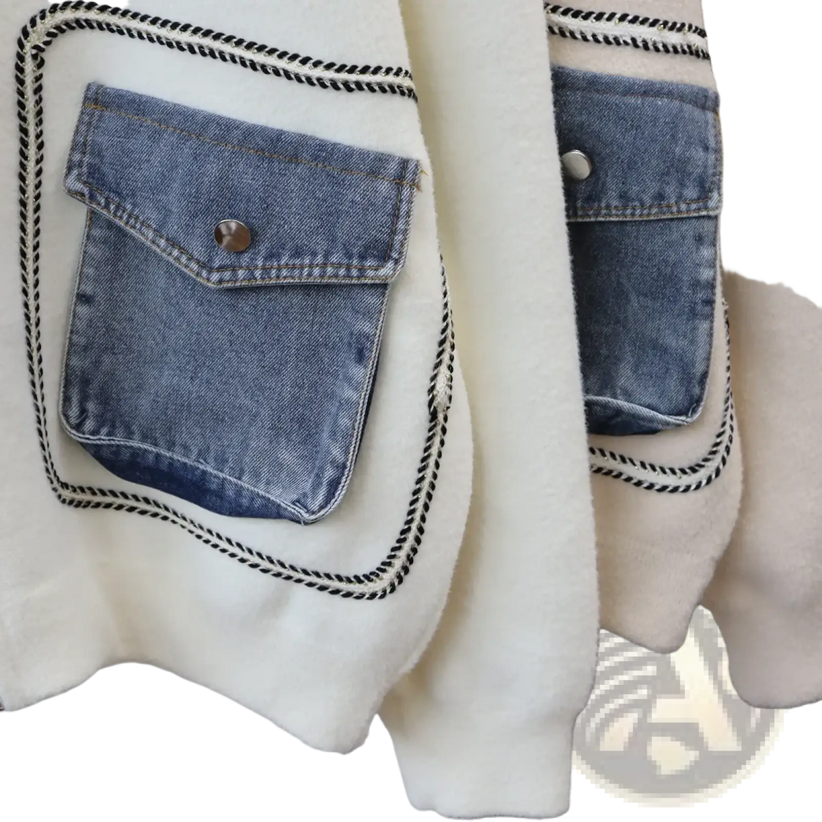 White faux shearling jacket with denim patch pockets and black-trimmed stitching for stylish outerwear use