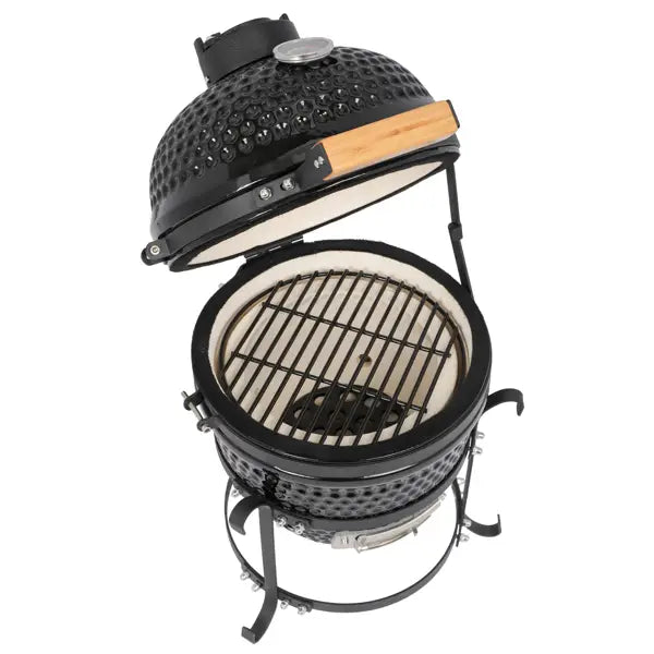 Black ceramic 13 inch kamado charcoal grill with a perforated dome lid, wooden handle, and metal grate inside.