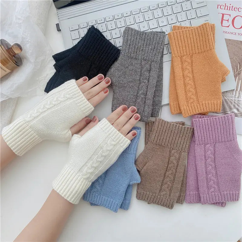 a pair of white unisex woolen fingerless gloves featuring a cable knit pattern and ribbed cuffs