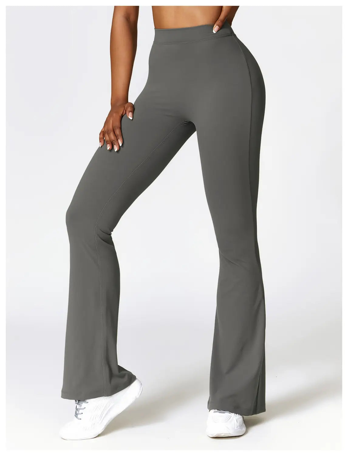 Gray high-waist flared yoga pants made of smooth stretchy fabric designed for active use.