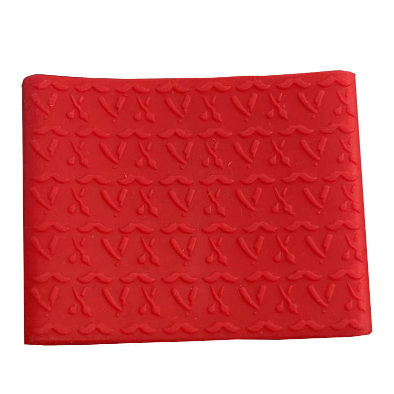 Red anti-slip silicone hair clipper grip ring with embossed scissors pattern.