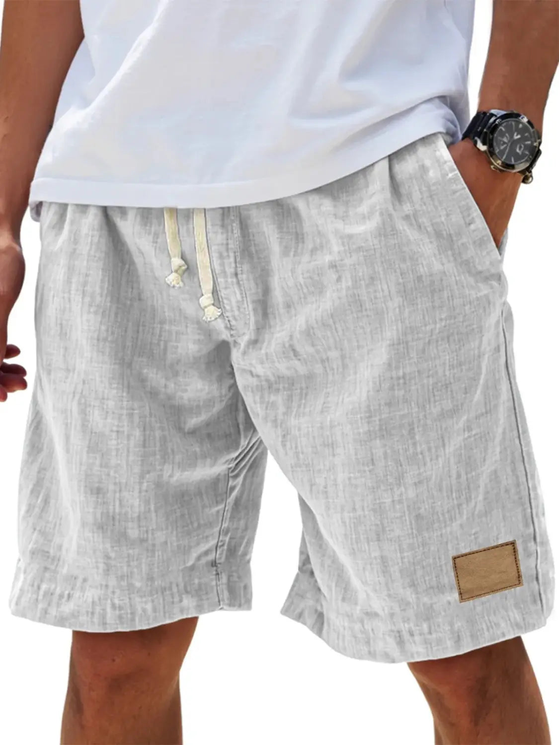 Light gray men linen holiday shorts with a subtle textured weave featuring cream-colored drawstrings and a brown leather patch designed for a retro breathable loose fit.