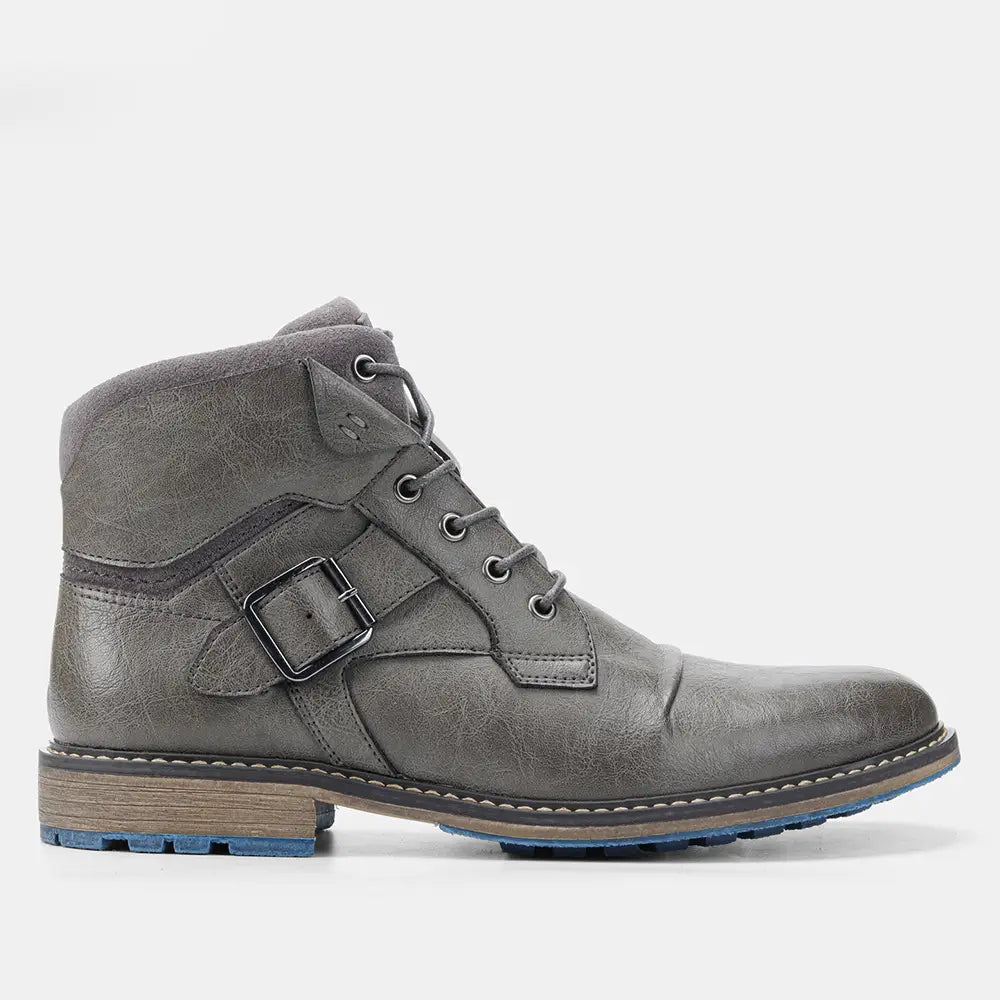 Gray suede men’s leather martin ankle boot with black buckle strap and blue rubber sole.