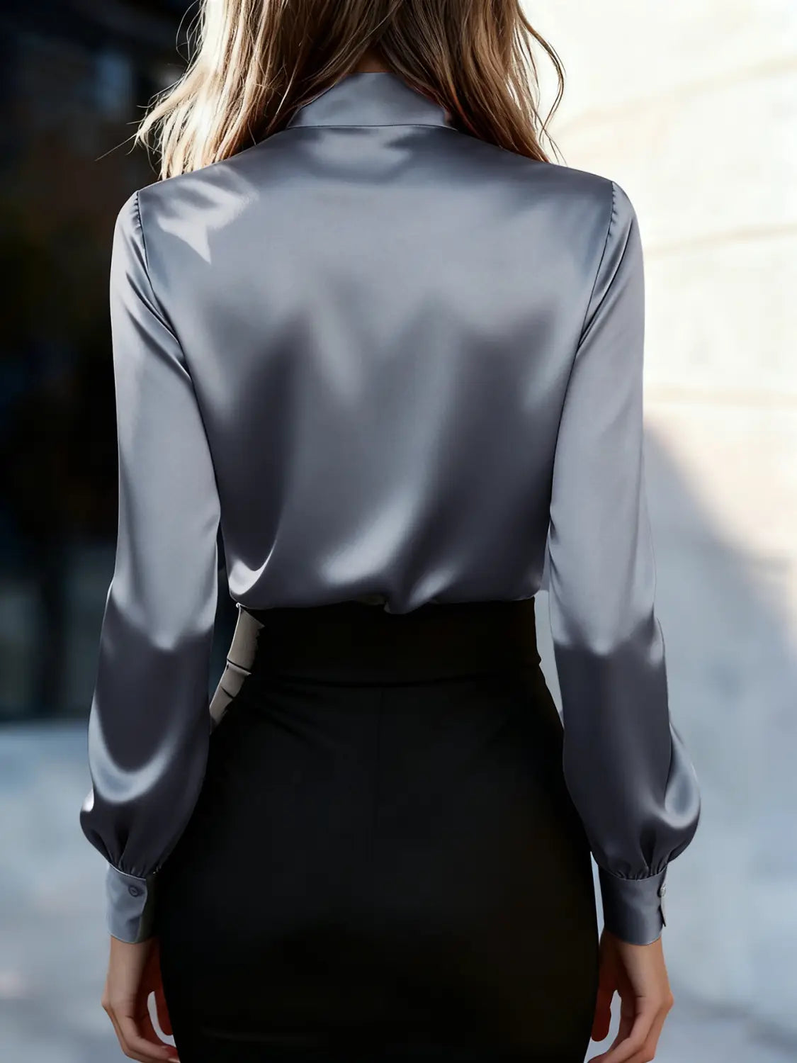 A sleek satin-gray long-sleeved blouse with a high neck satin bow, puff sleeves, and subtle sheen.