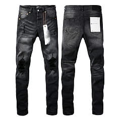 Men’s distressed slim fit patchwork denim jeans in black with ripped knees showing a slim fit silhouette.