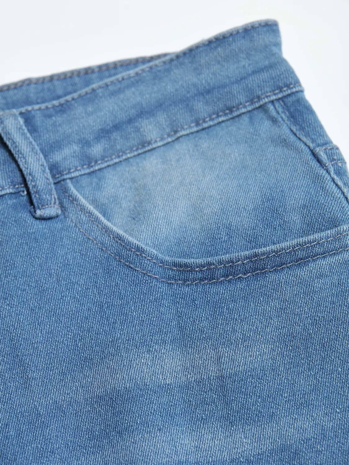 men’s distressed slim fit stretch denim jeans in medium-wash blue featuring a classic stitched pocket and waistband