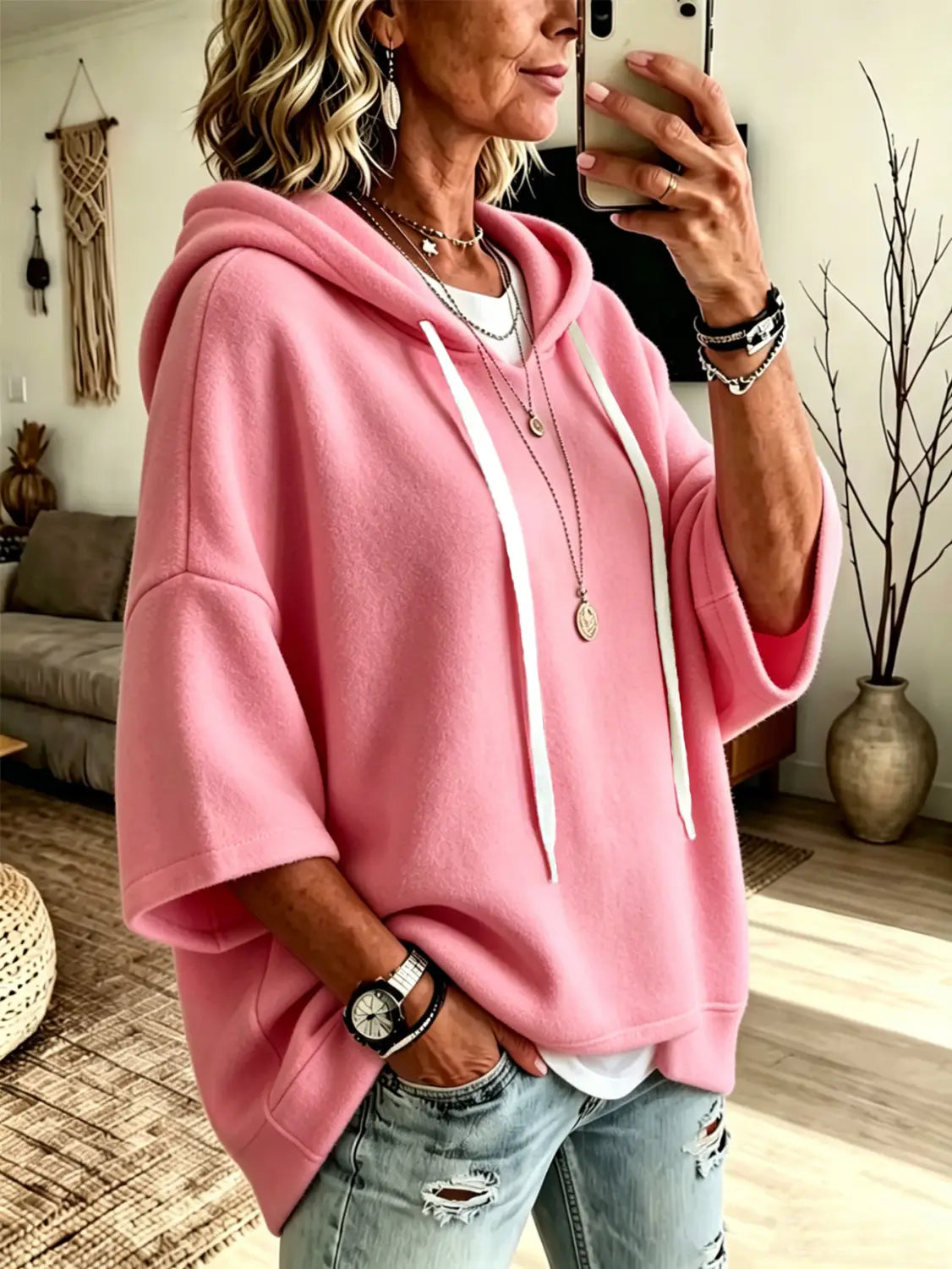 pink oversized fleece hooded top with three-quarter sleeves and white drawstrings in a casual style