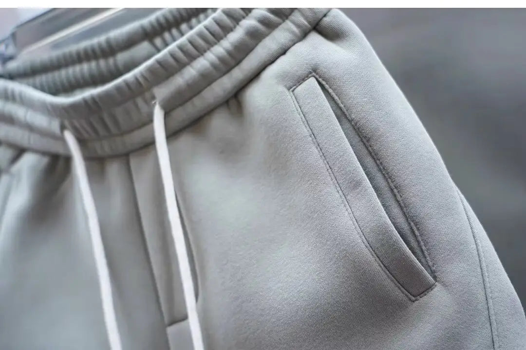 mens casual solid color sweatpants in gray featuring a ribbed elastic waistband with white drawstrings for comfortable everyday wear