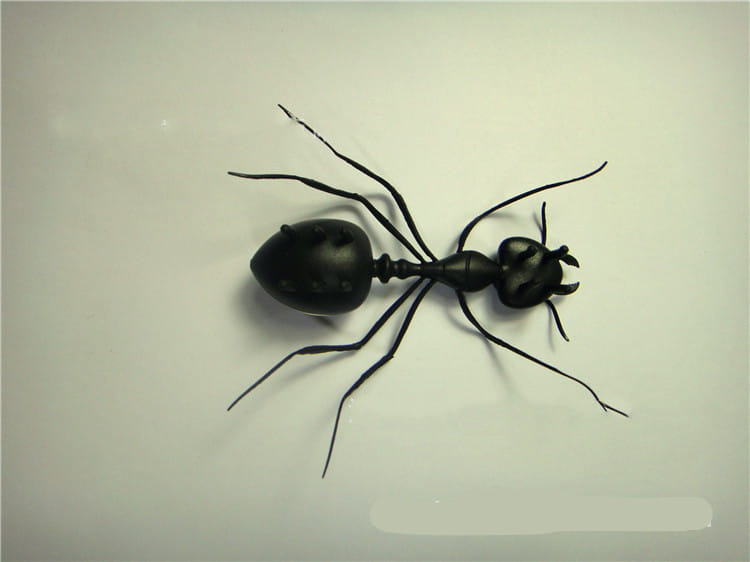Black metal ant figurine with detailed segmented body and articulated legs in a solar ant electronic robot toy for kids 93mm.