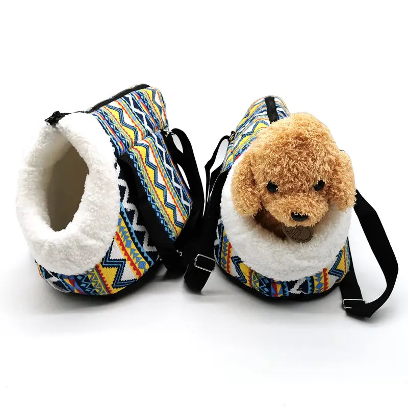 Colorful geometric-patterned warm pet carrier made of canvas with plush white fleece lining and black straps for travel.