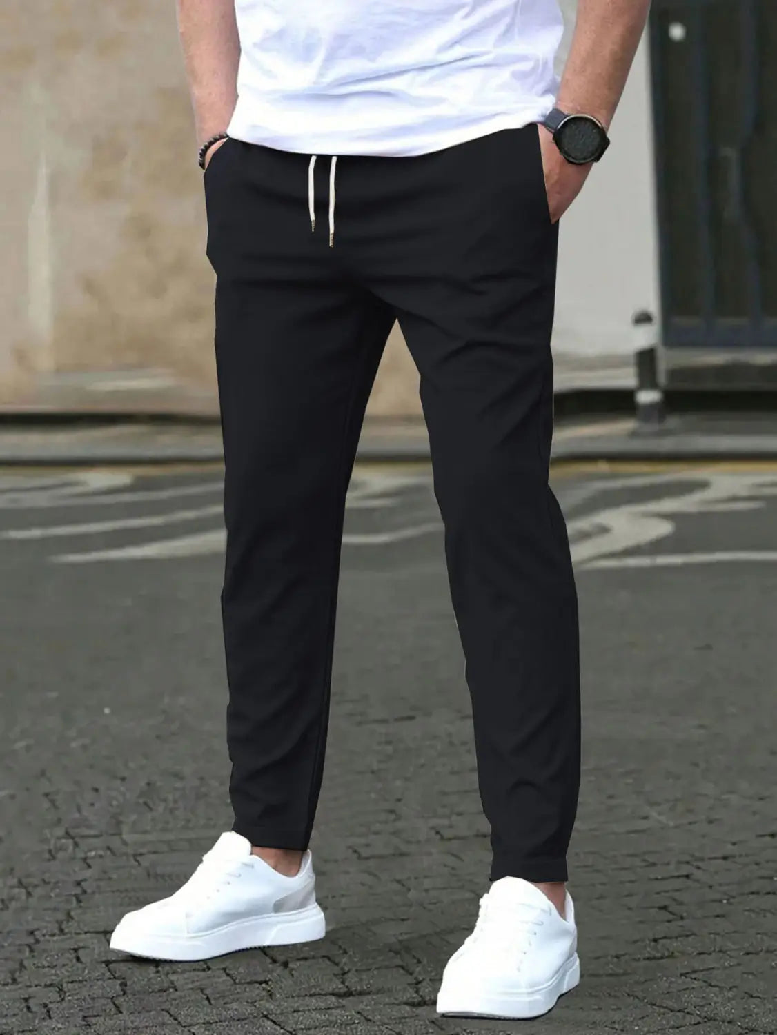 Slim fit tapered black jogger pants with white drawstrings made from comfortable material for casual wear.