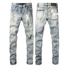 Men’s distressed slim fit patchwork denim jeans in light-wash with faded blue and white patches and ripped knees.