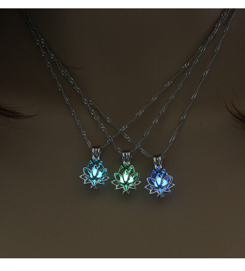 Three luminous lotus flower glow pendant necklaces in blue and green set on silver chains.