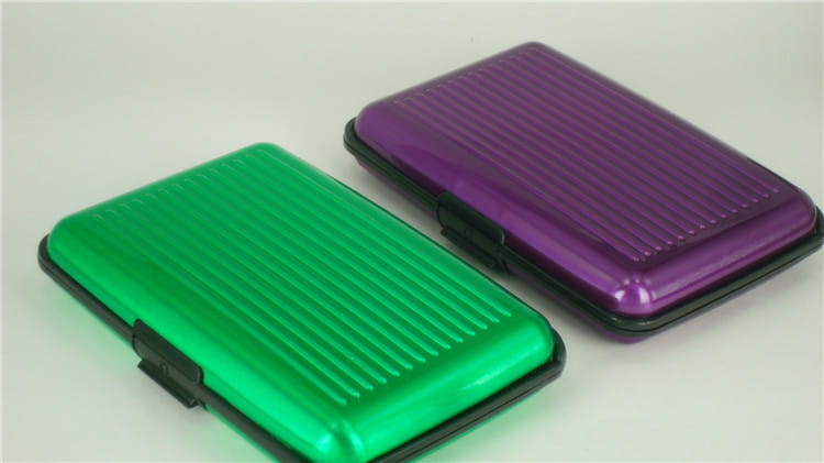 Green and purple metallic RFID blocking aluminum alloy ribbed card holder cases with black edges.